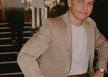 Barret Carnahan sitting with a brown blazer