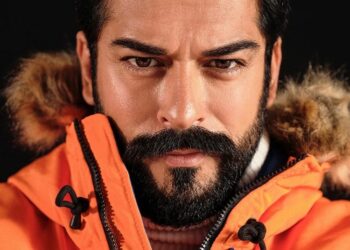 Burak Ozcivit in orange jacket