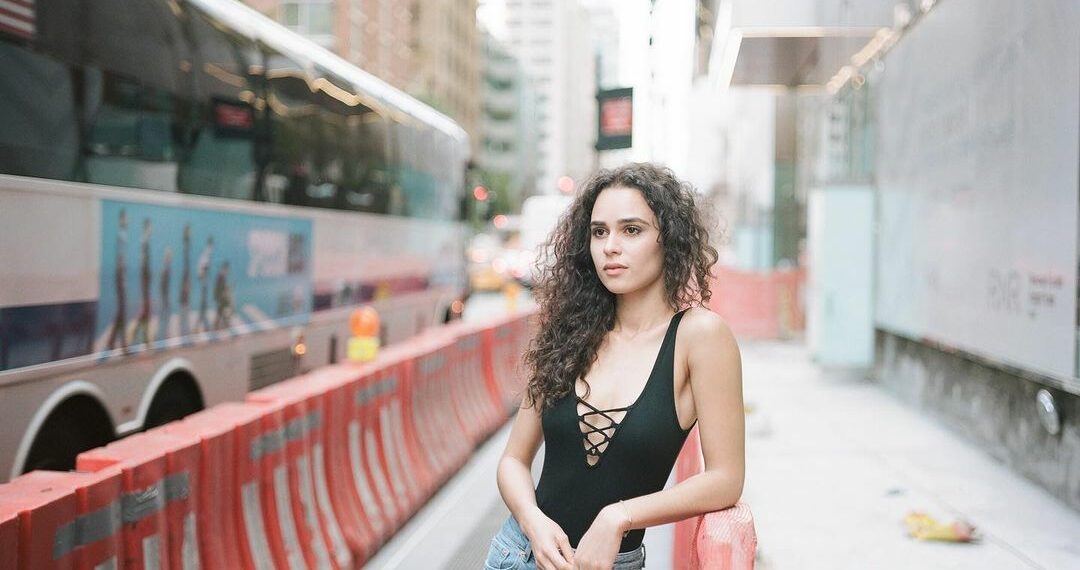 Marianly Tejada in deep neck black top