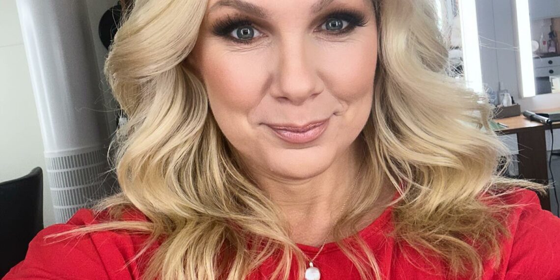 Anna Brolin taking selfie wearing red top