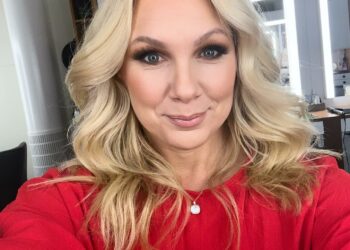 Anna Brolin taking selfie wearing red top