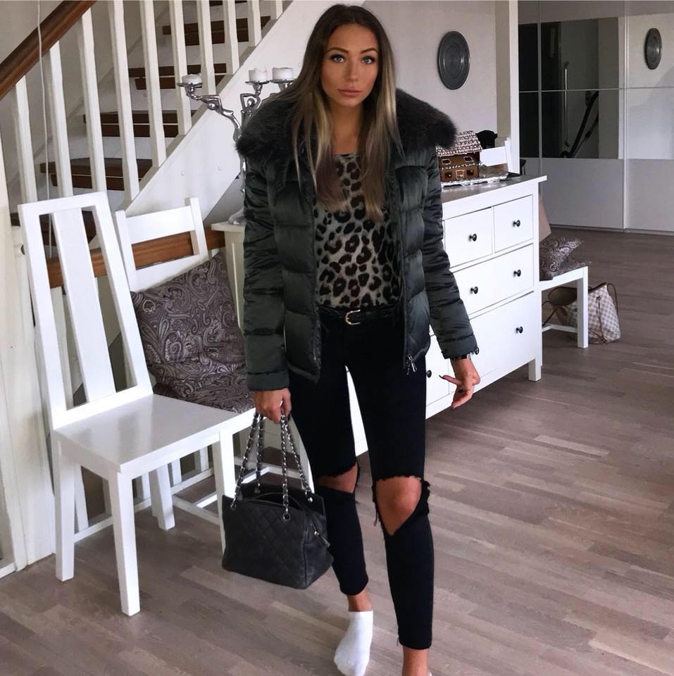 Nicci Hernestig wearing black jeans, top and jacket and holding a black bag.