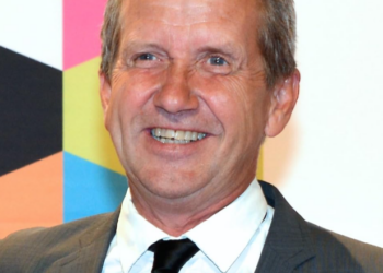 Martin Timell wearing white shirt and black coat