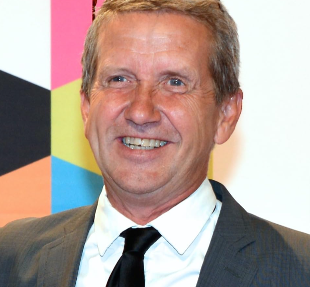 Martin Timell wearing white shirt and black coat